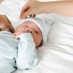 Motherswork x Le Petit Society Baby Organic Knotted Hat in Blue Stripes