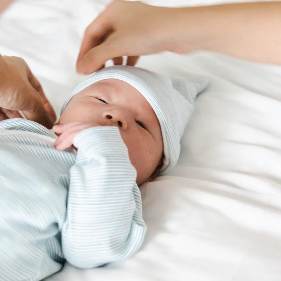 Motherswork x Le Petit Society Baby Organic Knotted Hat in Blue Stripes